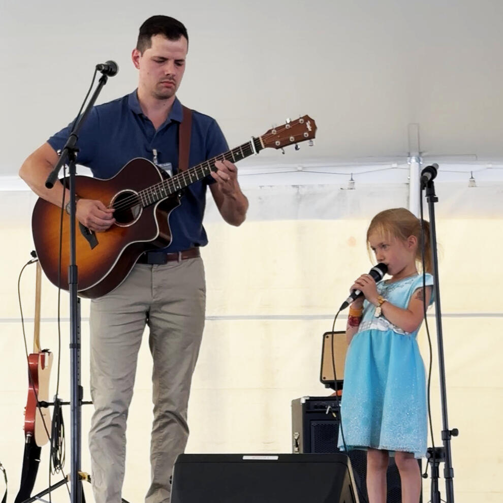 My daughter and me sharing a song together at a festival in southern Alberta. Her first time onstage!